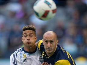 Vancouver Whitecaps' Erik Hurtado, left, and New York Red Bulls' Aurelien Collin vie for position as they watch the ball during first half MLS soccer action in Vancouver, Saturday, September 3, 2016.