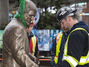 A statue of Vancouver Canucks legend Pat Quinn is installed outside Rogers Arena on Wednesday.