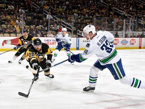 Henrik Sedin #33 of the Vancouver Canucks takes a shot against Ian Cole #28 of the Pittsburgh Penguins at PPG Paints Arena on February 14, 2017 in Pittsburgh, Pennsylvania.