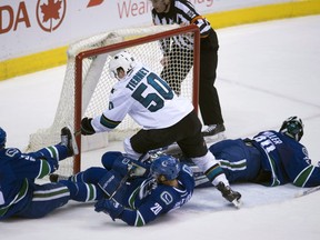 Chris Tierney fails to get a shot past Vancouver Canucks goalie Ryan Miller