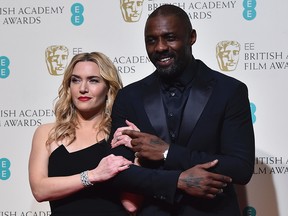 Award presenters British actors Kate Winslet (L) and Idris Elba (R) pose together in the winners area at the BAFTA British Academy Film Awards at the Royal Opera House in London on February 14, 2016. The two are filming a movie in Vancouver.