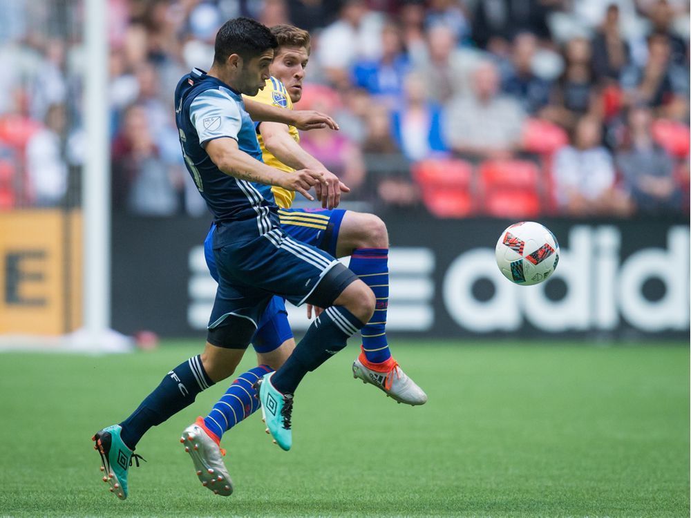 Vancouver Whitecaps' Matias Laba, left, and Colorado Rapids' Dillon Powers vie for the ball during first half MLS soccer action in Vancouver, B.C., on Saturday, July 9, 2016.