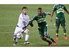 Dairon Asprilla (27) fights for the ball in the first half at Providence Park.