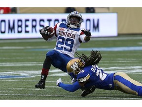 Winnipeg Blue Bombers linebacker Tony Burnett dives to tackle Jewel Hampton of the Montreal Alouettes during a preseason game last year in Winnipeg. Burnett is a recent free-agent signing of the B.C. Lions.