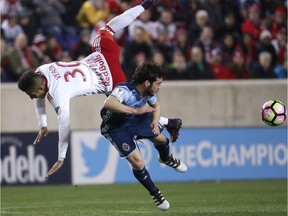 New York Red Bulls midfielder Gonzalo Veron, left, and Vancouver Whitecaps midfielder Russell Teibert collide while competing for the ball during the second half of a CONCACAF Champions League quarter-final match Feb. 22 in Harrison, N.J.