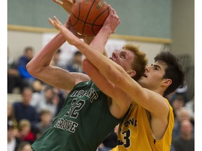 Cowley of the Walnut Grove Gators, left, works to shoot as he is smothered by Kelowna Owls' Owen Keyes in the championship final of the Terry Fox 28th annual Legal Beagle Invitational boys basketball torunament in Port Coquitlam on Jan. 7, 2017.