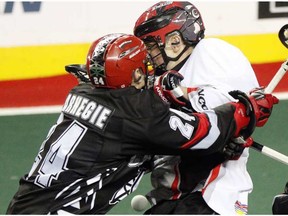 Roughnecks Scott Carnegie lays a hit on Cliff Smith as the Calgary Roughnecks made a second half comeback against the Vancouver Stealth, but couldn't come away with the win losing 13-10 in NLL regular season action at the Scotiabank Saddledome in Calgary, Alta., on February 18, 2017.