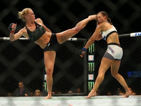 LAS VEGAS, NV - MARCH 5:  UFC bantamweight champion Holly Holm (L) kicks Miesha Tate takes during UFC 196 at the MGM Grand Garden Arena on March 5, 2016 in Las Vegas, Nevada. (Photo by Rey Del Rio/Getty Images)