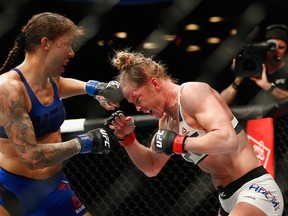 Germaine de Randamie of The Netherlands throws a punch against Holly Holm of United States in their UFC women's featherweight championship bout during UFC 208 at the Barclays Center in New York on Saturday. De Randamie won the fight.