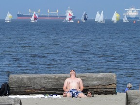 Soaking up the sun at Vancouver’s Kitsilano Beach. The Lower Mainland’s climate is predicted to make it the new San Diego, but at a cost.