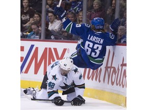 Joel Ward flips Philip Larsen along the boards.