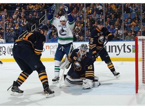 Alex Burrows celebrates a goal by teammate Michael Chaput against Robin Lehner.