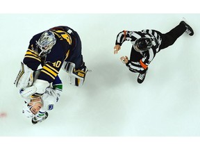 Robin Lehner of the Sabres battles Alex Burrows.