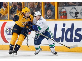 Rookie defenceman Troy Stecher of the Vancouver Canucks, who calls Richmond home, ties up Filip Forsberg of the Nashville Predators at Bridgestone Arena on Jan. 10, 2017 in Nashville, Tenn.