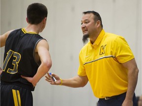 Kelowna Owls coach Harry Parmar talks with a player during a break in play against the Walnut Grove Gators at the 2016 Tsumura Basketball Invitational in Langley in December.