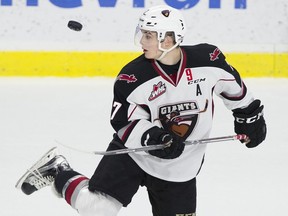 Ty Ronning bounces the puck off his skate in the pre game skate prior to playing the Kelowna Rockets.