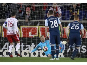 Vancouver Whitecaps goalkeeper David Ousted blocks a penalty kick by New York Red Bulls midfielder Sacha Kljestan during last week's first leg.