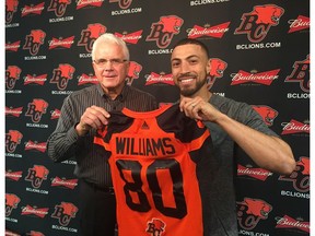 GM and coach Wally Buono hands Chris Williams his new jersey on Friday after the B.C. Lions struck a deal with the lethal receiver to suit up for the Leos this CFL season.