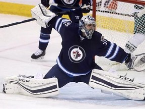 Winnipeg Jets goalie Ondrej Pavelec (31) stretches out to stop a shot by Minnesota Wild&#039;s Jason Zucker (not shown) during first period NHL hockey action in Winnipeg, Tuesday, February 7, 2017. Pavelec has undergone knee surgery and is likely out for the rest of the season. THE CANADIAN PRESS/Trevor Hagan