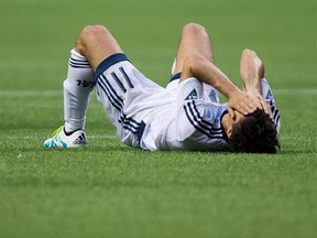 Vancouver Whitecaps&#039; Nicolas Mezquida lies on the field after losing the Canadian Championship soccer final to Toronto FC on aggregate in Vancouver, B.C., on June 29, 2016. It was a finish that will never sit quite right with Carl Robinson. The Vancouver Whitecaps were moments away from their second consecutive Canadian Championship last June when rivals Toronto FC heaved a hopeful, desperate ball into the penalty area. Before anyone could blink the ball was blasted into the roof of Vancouver&#039;s
