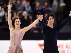 Tessa Virtue and Scott Moir celebrate as they finish the senior ice dance free dance to take gold at the National Skating Championships in Ottawa on Saturday, Jan. 21, 2017. When Virtue and ice dance partner Moir returned to competition after a two-year hiatus, they decided to shake things up, moving to Montreal to train with coaches Marie-France Dubreuil and Patrice Lauzon from their previous home in Canton, Mich. THE CANADIAN PRESS/Sean Kilpatrick