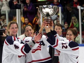 FILE - In this April 9, 2005, file photo, U.S. team members, from left, Angela Ruggiero, Cammi Granato and Jenny Potter hold the trophy after winning the the Women&#039;s World Ice Hockey Championship in the Cloetta Center in Linkoping, Sweden. Granato&#039;s biggest victory in hockey came 12 years after she retired. When USA Hockey and the women&#039;s national team agreed to a contract that ended a wage dispute, Granato couldn&#039;t put her happiness into words. (Jonas Ekstromer/Pressens Bild via AP, File)