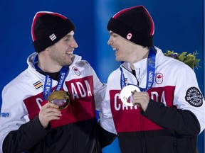 Canadian moguls gold medallist Alex Bilodeau and silver medallist Mikael Kingsbury share a laugh after receiving their medals during a ceremony at the Sochi Winter Olympics on Feb. 11, 2014, in Sochi, Russia. With another Winter Games looming, Canada's commitment to medal counts is an open question amid a review of Own the Podium funding.