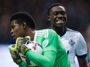 Alphonso Davies, back, reacts as Philadelphia Union goalkeeper Andre Blake makes a save during the second half of an MLS soccer game in Vancouver, B.C., on Sunday March 5, 2017.