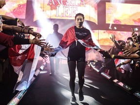 Vancouver-born (Unstoppable) Angela Lee walks to the floor during One Championship's inaugural atomweight (115-pound) world title in Singapore last May. 
The undefeated Lee takes on Taiwan’s Jenny Huang (5-0-0) this Saturday in Bangkok.