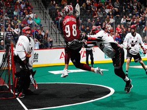 Tye Belanger of the Vancouver Stealth makes a save on Callum Crawford of the Colorado Mammoth on Sunday in Denver.
