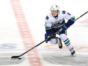 Brock Boeser of the Canucks plays the puck down the ice during second period action against the Jets.