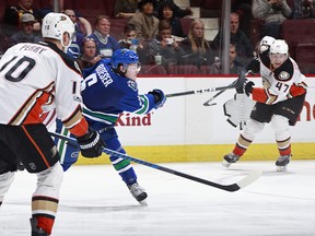 Corey Perry of the Ducks looks on as Brock Boeser of the Canucks.