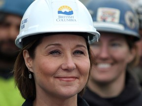 Premier Christy Clark looks on as an ironworker from Local 97 and the union representing more than 1,800 ironworkers in B.C. announce they're endorsing the Liberals during a news conference at a construction site along Johnston Street in Victoria on Wednesday.