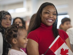 Vancouver, BC: MARCH 29, 2017 -- Thirty new Canadians from 15 different countries took their oath of Canadian citizenship at the ISS of BC Welcome Centre in Vancouver, BC Wednesday, March 29, 2017. Pictured is Messia Ditshimba, originally from Congo, and daughter Akira, 3, at the ceremony.