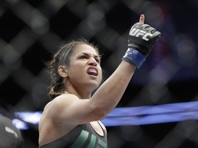 Cynthia Calvillo celebrates after defeating Amanda Cooper during a strawweight mixed martial arts bout earlier this month in Las Vegas.