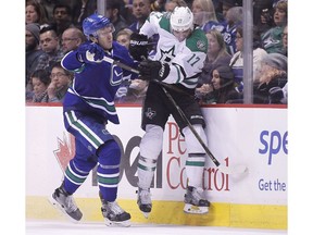 Nikita Tryamkin of the Vancouver Canucks staples Devin Shore of the Dallas Stars to the boards during Thursday's NHL action at Rogers Arena in Vancouver.