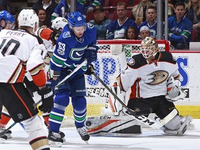 Jonathan Bernier of the Ducks makes a save as Philip Larsen lurks nearby.