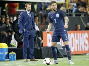 England's team manager Gareth Southgate watches the friendly soccer match between Germany and England in Dortmund, Germany, Wednesday. England hosts Lithuania this weekend.