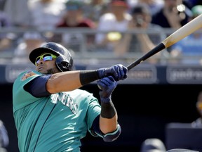 FILE - In this Feb. 26, 2017, file photo, Seattle Mariners' Nelson Cruz watches his solo home run during the second inning of a spring training baseball game against the San Diego Padres,in Peoria, Ariz. Going into the 45th season since the designated hitter was approved by MLB owners for the American League, more managers now seem willing to spread around the DH starts instead of penciling the same player in the lineup just about every day.