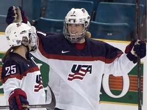 FILE - In this Nov. 4, 2014, file photo, Team United States' Monique Lamoureux, right, celebrates her goal against Team Finland with teammate Alex Carpenter during the third period at the Four Nations Cup women's hockey tournament in Kamloops, British Columbia. The U.S. women's hockey team is threatening to boycott the world championships because of a wage dispute. The team announced Wednesday that they will not participate in the International Ice Hockey Federation tournament that begins March 31, 2017, in Plymouth, Michigan.