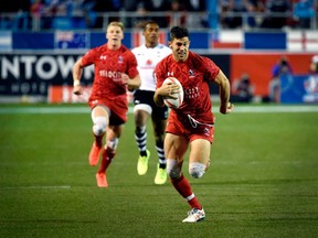 Justin Douglas of Canada runs in for a try during the USA Sevens