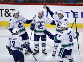 Reid Boucher, center, celebrates his goal with teammates.