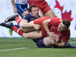 Canada's Isaac Jonathan Kaay, front, scores a try as Scotland's Scott Riddell defends during World Rugby Sevens Series action, in Vancouver, B.C., on Saturday March 11, 2017.