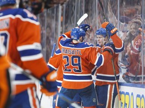 Edmonton Oilers' Leon Draisaitl and Connor McDavid celebrate McDavid's goal during the second period of Saturday's game against the Vancouver Canucks in Edmonton.