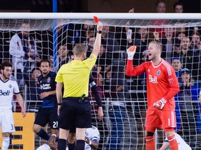 Referee Drew Fischer issues a red card to Vancouver Whitecaps goalkeeper David Ousted (1) after a play against the San Jose Earthquakes during the first half at Avaya Stadium.