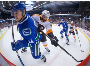 With only 13 games left in the team's regular season, Vancouver Canucks GM Jim Benning said fans can expect to see more ice time for the club's new and younger players like Reid Boucher, checked here by Philadelphia Flyers' Pierre-Edouard Bellemare.