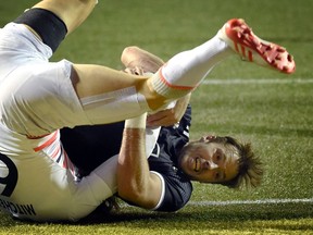 Tim Mikkelson of New Zealand is tackled by Tom Mitchell of England as he scores a try during day two of the USA Sevens Rugby tournament, part of the World Rugby Sevens Series, March 4, 2017 in Las Vegas, Nevada.