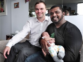 Spencer (l) and Romi Chandra Herbert with their new baby Dev in Vancouver, BC., February 27, 2017.
