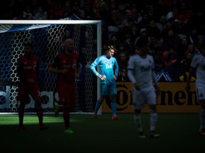 Vancouver Whitecaps goalkeeper Spencer Richey, centre, looks on after allowing a goal to Toronto FC's Victor Vazquez during second half action at B.C. Place on Saturday.