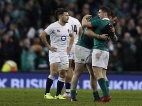 Players react at the final whistle in the Six Nations international rugby union match between Ireland and England at the Aviva Stadium in Dublin on March 18, 2017.